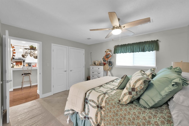 carpeted bedroom featuring ceiling fan and a closet