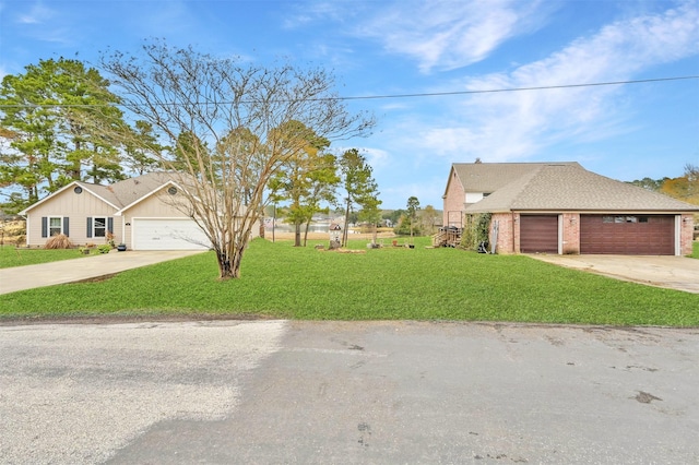 view of front of property with a garage and a front lawn