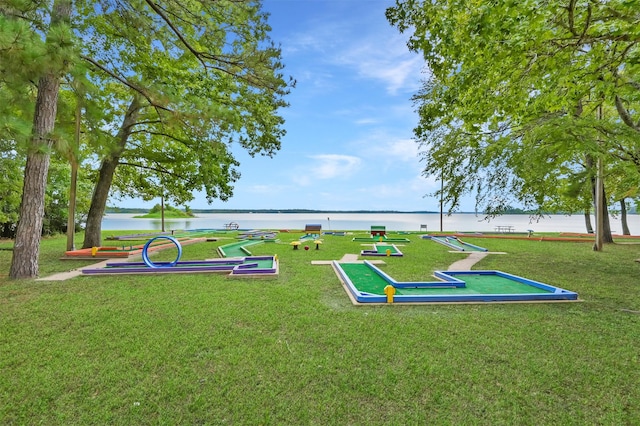 surrounding community featuring a water view and a yard