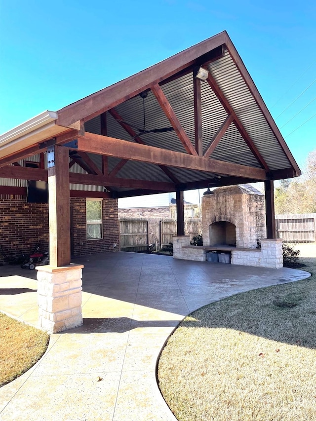 view of patio / terrace with a gazebo and an outdoor stone fireplace