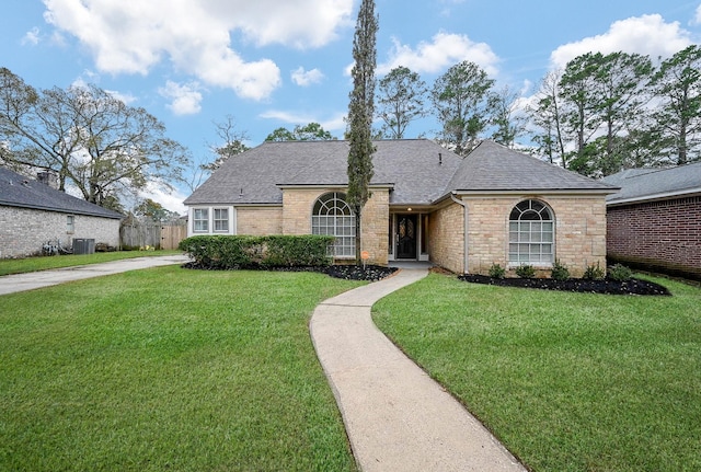 view of front of home featuring central AC and a front lawn