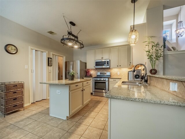 kitchen featuring sink, decorative light fixtures, stainless steel appliances, and decorative backsplash