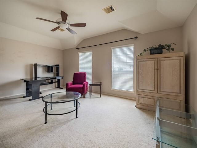 sitting room featuring ceiling fan, light colored carpet, and vaulted ceiling