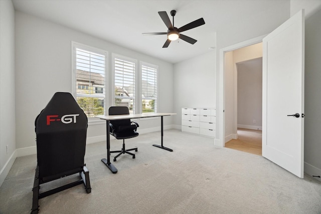 carpeted office featuring ceiling fan