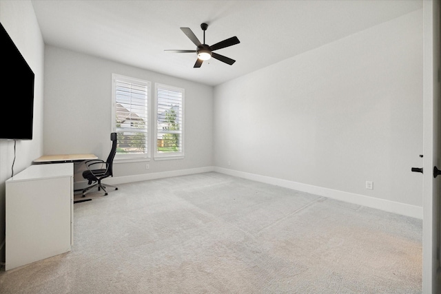 unfurnished office with ceiling fan and light colored carpet