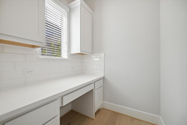 unfurnished office featuring light hardwood / wood-style floors