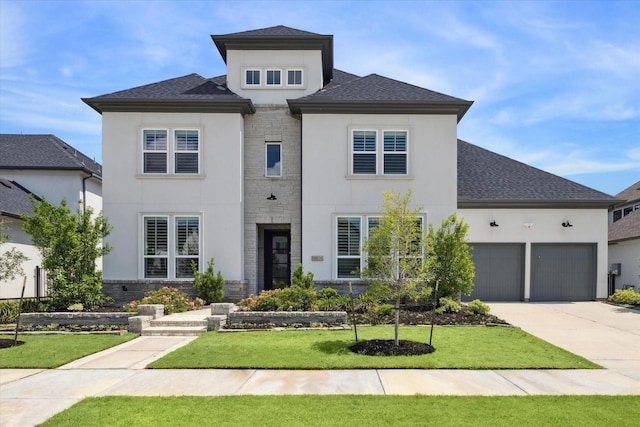 view of front of house featuring a garage and a front lawn