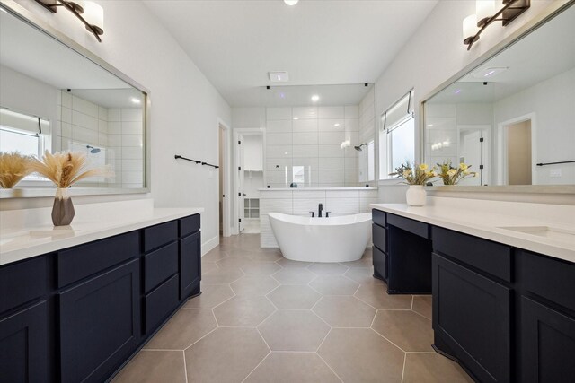 bathroom featuring vanity, tile patterned floors, and separate shower and tub