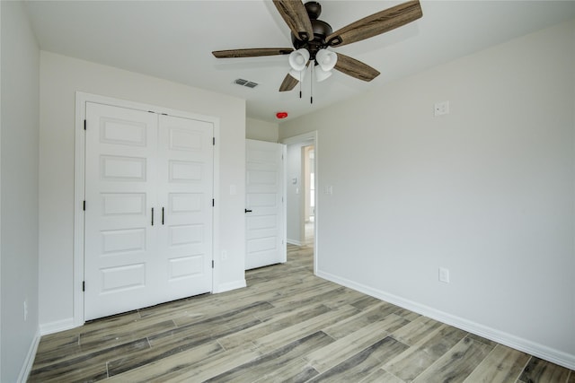 unfurnished bedroom with a closet, ceiling fan, and light hardwood / wood-style flooring