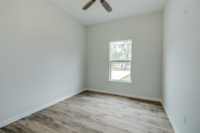 empty room with ceiling fan and light wood-type flooring