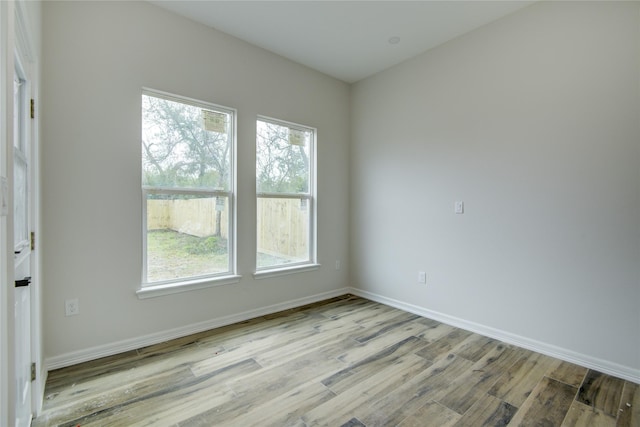 spare room with light wood-type flooring