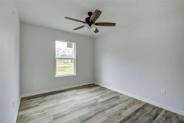 spare room featuring light hardwood / wood-style floors and ceiling fan