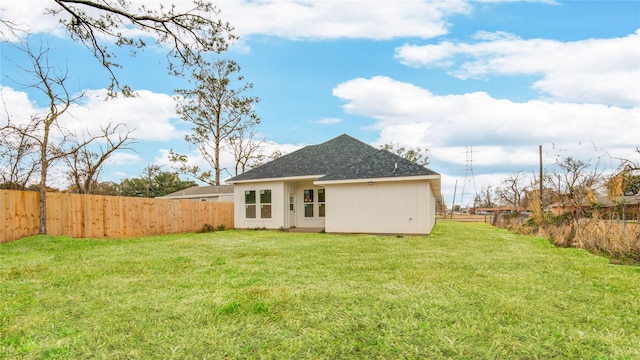 rear view of property with a lawn