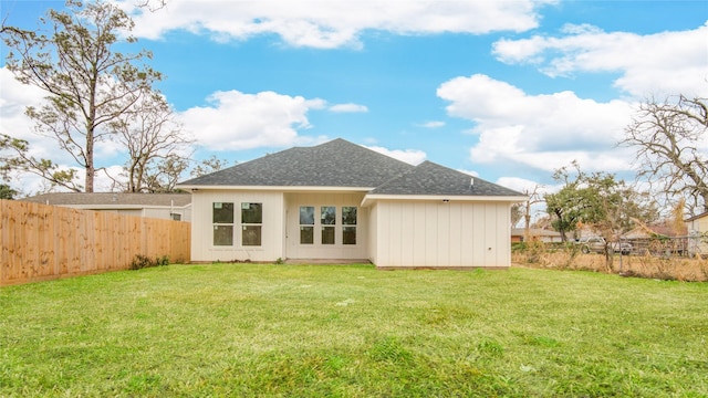 rear view of property featuring a yard