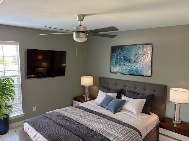 tiled bedroom featuring ceiling fan