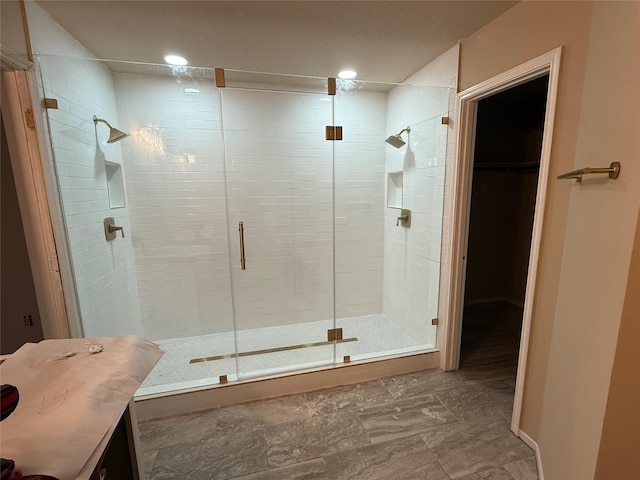 bathroom featuring a shower with shower door