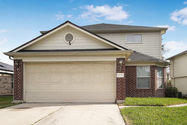 view of front of property featuring a garage and central AC unit