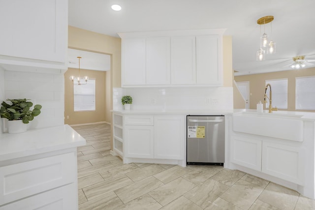 kitchen featuring white cabinetry, stainless steel dishwasher, and hanging light fixtures