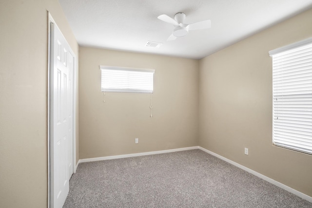 carpeted empty room with ceiling fan