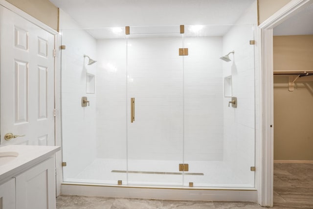 bathroom with vanity and a shower with door