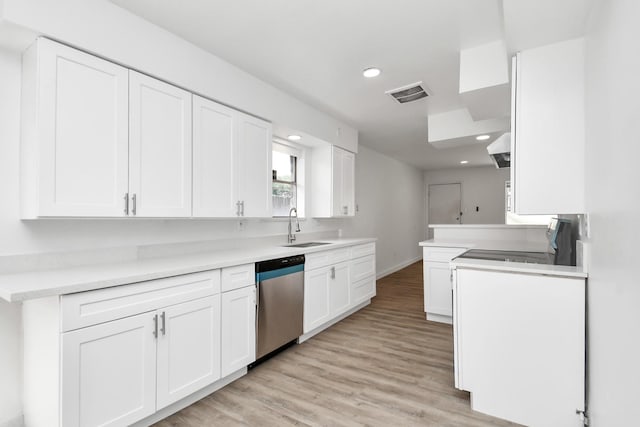 kitchen with dishwasher, sink, white cabinets, stove, and light hardwood / wood-style floors