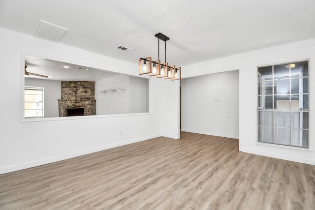 interior space featuring a fireplace and light hardwood / wood-style flooring