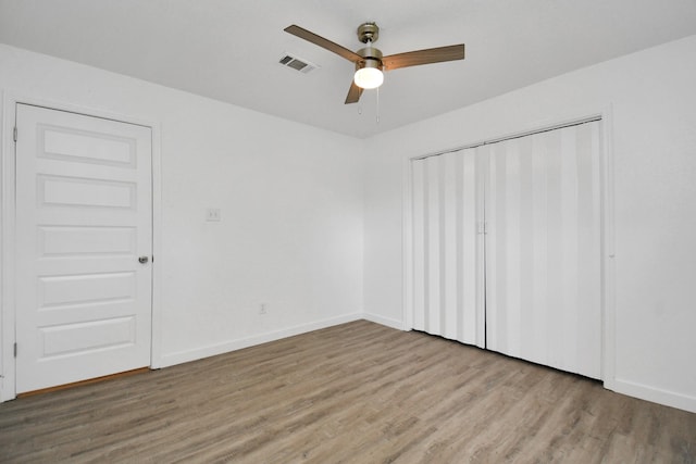 unfurnished bedroom with ceiling fan, light hardwood / wood-style floors, and a closet