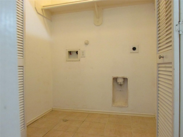 clothes washing area with hookup for a washing machine, gas dryer hookup, hookup for an electric dryer, and light tile patterned floors