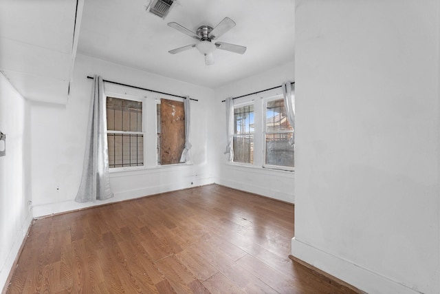 unfurnished room with hardwood / wood-style floors and ceiling fan