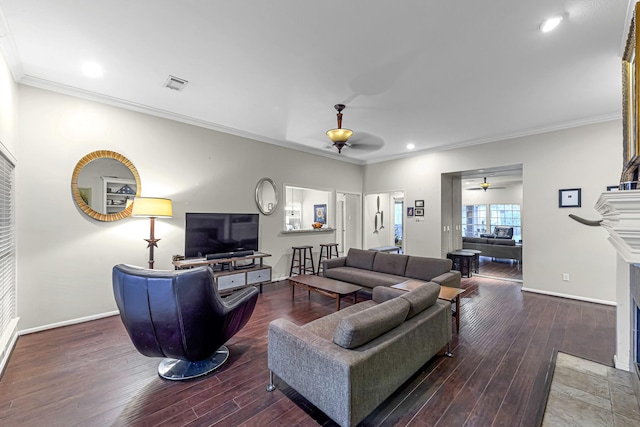 living room with ornamental molding, dark hardwood / wood-style floors, and ceiling fan