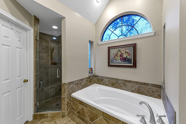 bathroom with shower with separate bathtub and vaulted ceiling