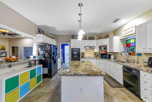 kitchen featuring hanging light fixtures, backsplash, black appliances, white cabinets, and a kitchen island