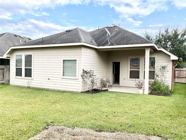 back of property featuring a patio area and a lawn