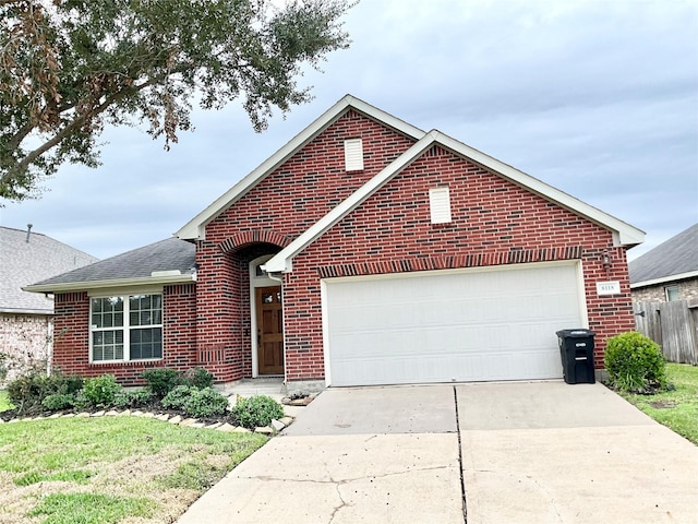 view of front of house with a garage and a front lawn