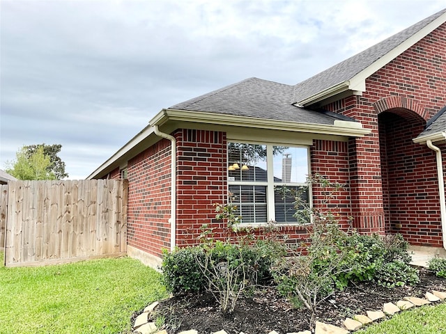 view of side of home with a lawn