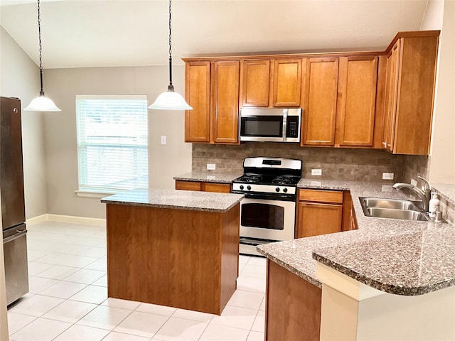 kitchen featuring pendant lighting, sink, light tile patterned floors, and stainless steel appliances