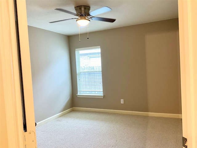 empty room with light colored carpet and ceiling fan