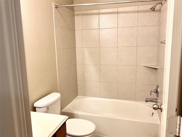 full bathroom with vanity, tiled shower / bath combo, and toilet