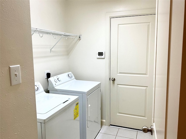 washroom featuring light tile patterned floors and washer and dryer