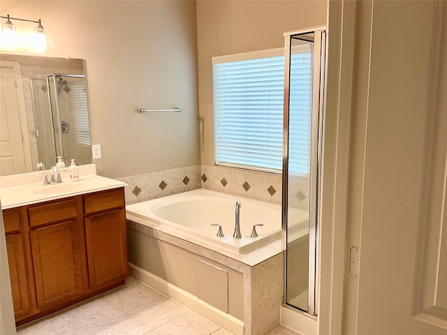 bathroom with plus walk in shower, vanity, and tile patterned floors