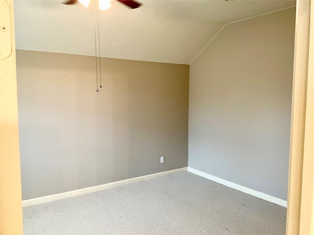 carpeted spare room with ceiling fan and lofted ceiling