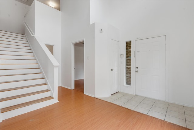 entrance foyer featuring a high ceiling and light hardwood / wood-style floors