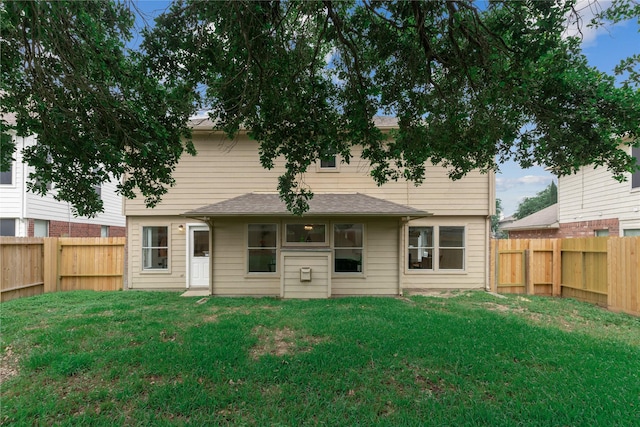 back of house with a yard