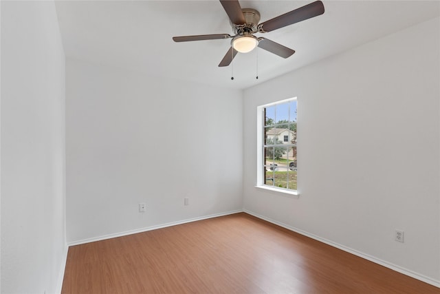 spare room with hardwood / wood-style floors and ceiling fan