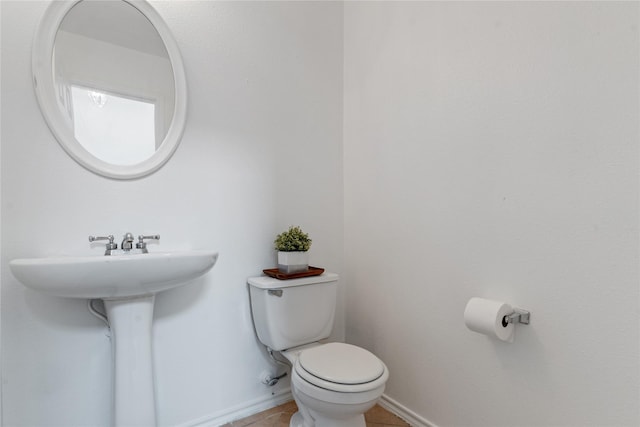 bathroom featuring tile patterned flooring, sink, and toilet