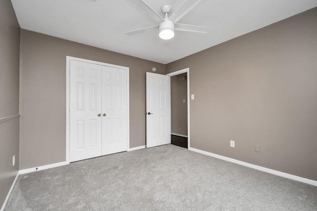 unfurnished bedroom featuring ceiling fan, carpet floors, and a closet