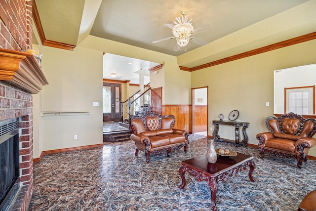 living room with crown molding and a fireplace