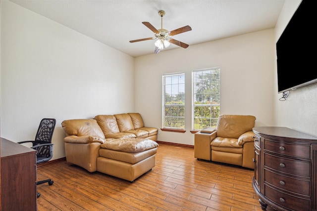 office with ceiling fan and light hardwood / wood-style flooring