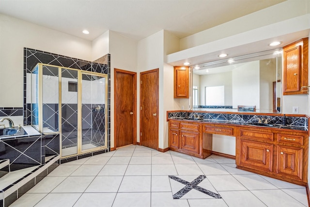 bathroom featuring tile patterned floors, vanity, and shower with separate bathtub