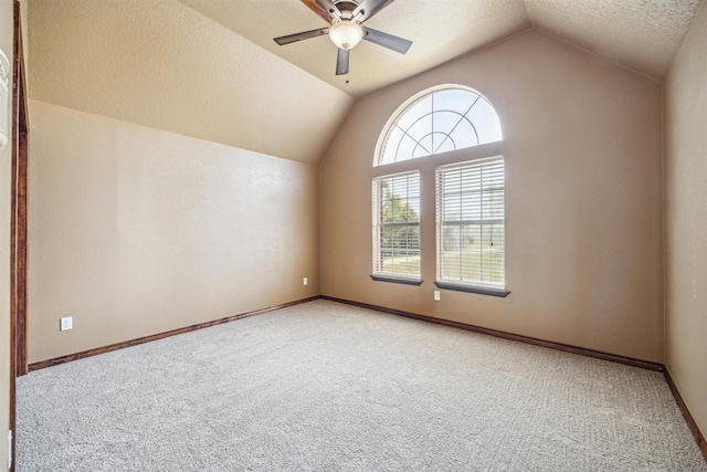 additional living space with ceiling fan, lofted ceiling, carpet, and a textured ceiling